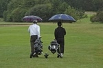 Aktivitäten bei Regen auf Mallorca Golfspieler auf dem Platz mit Schirm